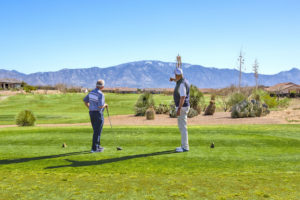 Two people golfing in a 55+ active adult golf community in Arizona