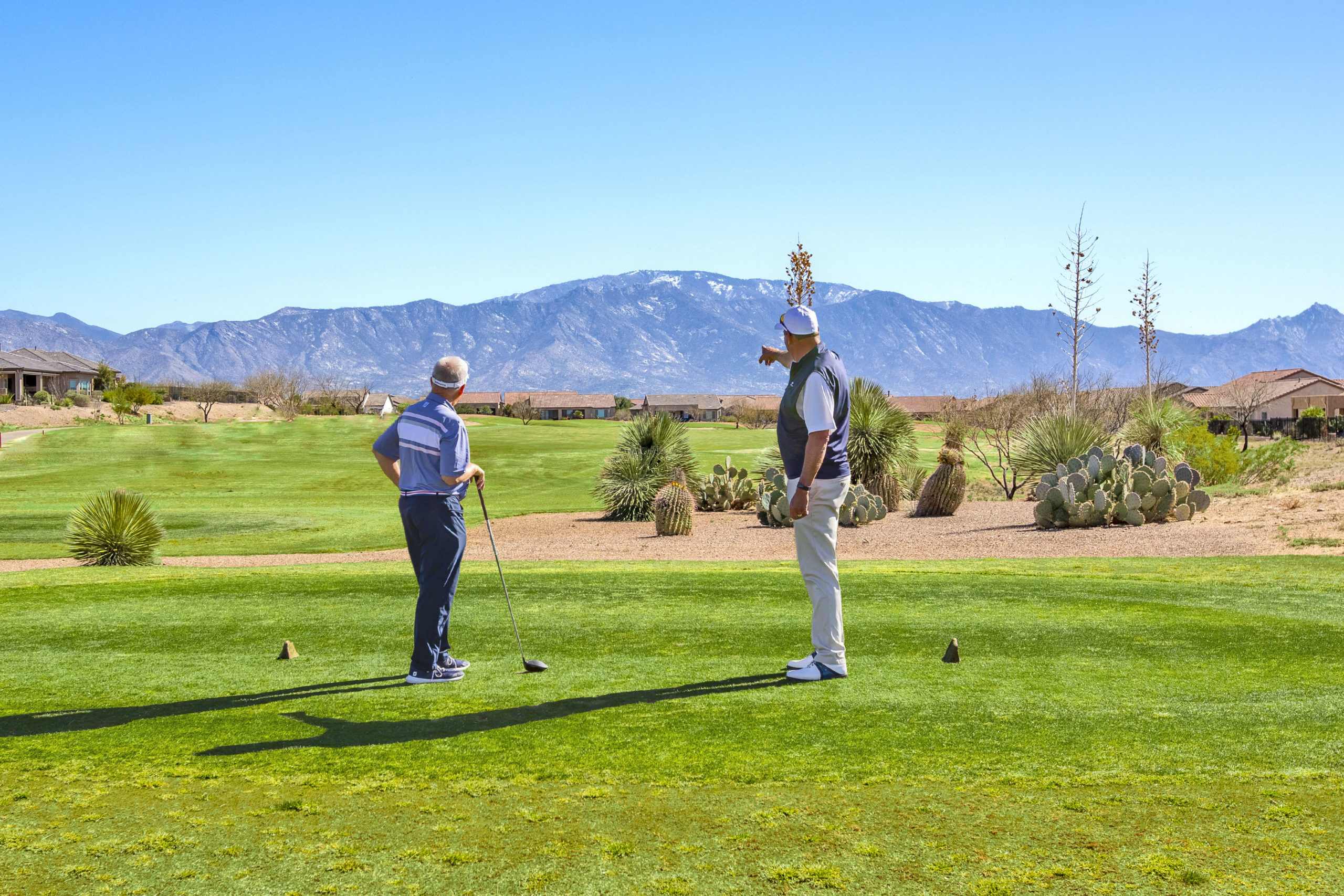 Two people golfing in a 55+ active adult golf community in Arizona